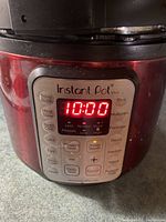 Close-up photo of Instant Pot Viva digital control panel showing 10:00 on the display with various cooking function buttons