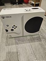 Original sealed box showing front view with console and controller image