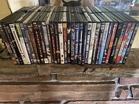 Front view of a large selection of DVDs arranged side by side, showing titles and artwork on spines.