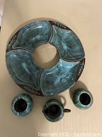 Top view of the sectional server and three vases showing color and shape details.