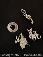 Top view of all four brooches showing the designs and arrangement