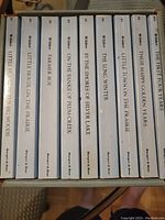 Spines of the complete set of 11 Little House books by Laura Ingalls Wilder showing titles and minor wear.