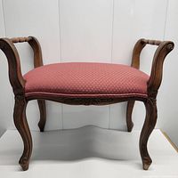 Front and side view of the Italian vanity bench showing the wooden legs, carved details, and pink upholstered seat.