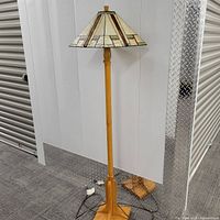 Full view of the lamp showing wooden base, tall stand, and square stained glass style shade.