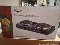 Box showing Master Chef logo, product image of double electric burner with two spiral coil heating elements, and text in French indicating variable temperature control.