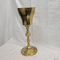 Full view of the brass plant stand or ice bucket, showing overall shape and design.