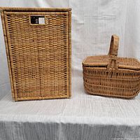 Front view of wicker hamper and picnic basket side by side