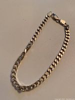 Front angle photo showing the thickness, shape, and clasp of the sterling silver men's link bracelet.