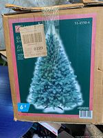 Box showing image of assembled 6-foot Kentucky Spruce artificial Christmas tree with green foliage.