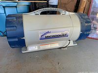 Front view showing the main body and dual fan end caps with the Workshop Microdust label.