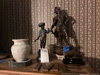 Wide view of lot showing all items on table with patterned wallpaper background.