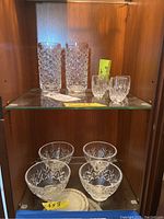 Top shelf showing two tall highball glasses and two shot glasses