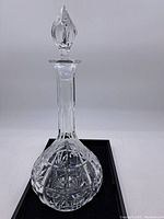 Full view of crystal decanter with stopper showing shape and top design