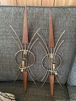 Front view of both wall-mounted candle holders showing starburst design