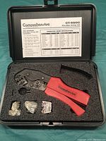 Open carrying case showing Comprehensive CT-9500 crimp tool with three small accessory parts and crimp specification chart inside lid.