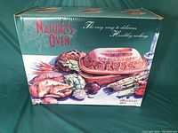 Original packaging box labeled 'Nature's Oven' featuring colorful images of foods and the clay oven product.