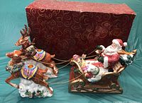 Full set with Santa in sleigh pulled by two reindeer, displayed with original red box featuring gold swirl design.