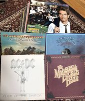 Front view of selected album covers showing AC/DC Flick of the Switch, The Marshall Tucker Band albums, and others.