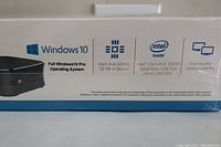 Close-up of product box side showing Windows 10 Pro logo, RAM and Storage details, Intel CherryTrail Z8350 quad-core processor details, and dual monitor display capability information.