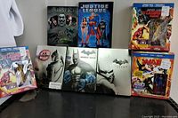 All items arranged together showing steelbooks and combo packs with figurines, no discs inside the cases