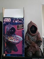 Star Wars Jawa candy bowl holder next to original box showing the figure and packaging design.
