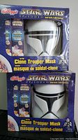 Front view of two Kellogg's Star Wars Episode II Clone Trooper Mask cereal boxes showing the Clone Trooper helmet mask through the window and branding on the box.