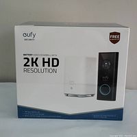 Front of sealed retail box showing brand logo, product image and '2K HD Resolution' text