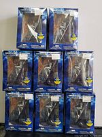 Eight boxed Silver Surfer figurines arranged in a pyramid shape showing front of boxes with visible figurines inside.