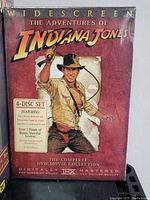 Front view of the Indiana Jones 4-disc DVD set packaging with the movie character artwork and text detailing the contents and features.