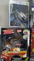 Iron Man themed mouse and mouse pad next to Air Hogs Megabomb RC helicopter in original packaging