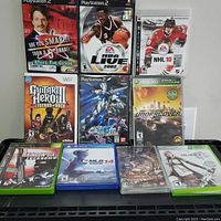 Photo displaying 10 console games in original cases for PS2, Wii, Xbox 360, and PS3.