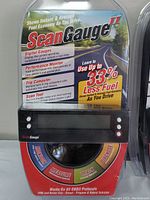 ScanGauge II unit in original plastic packaging showing product info and colors