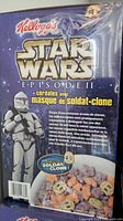 Front of Star Wars Episode II Kellogg's cereal box showing Clone Trooper mask in front window and cereal pieces.