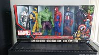 Front view of the packaging showing all 6 Marvel Titan Hero Series action figures in original packaging with visible characters including Wolverine, Iron Man Mark 2, Hulk, Spider-Man, Captain America, and Iron Man Stealth Strike.
