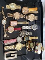 Full view of assorted wristwatches, showing variety including metal bracelets, leather straps, and a bracelet watch.