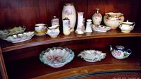 Wide view showing multiple pieces of Royal Vienna china including bowls, vases, teapot, sugar bowl, creamer, and cup.