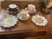 Overview of all three teacup sets and two leaf plates