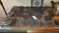 Full selection of cast iron trivets arranged on table