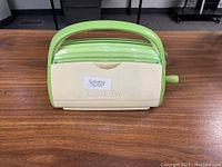 Front view of the Cuttlebug die cutting machine closed with label indicating model