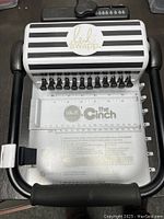 Top view of The Cinch book binding machine with Heidi Swapp branding showing punch pins and hole punch area.