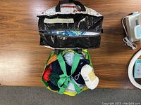 Top-down view showing two bags filled with assorted yarn skeins in multiple colors, including white, blue, red, green.