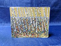 Front view of the rectangular glass paperweight showing the forest scene with birch trees inside the glass block.