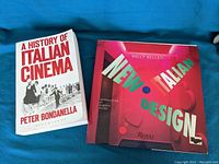 Two books placed side by side. 'A History of Italian Cinema' by Peter Bondanella with white cover and red text. 'New Italian Design' with colorful graphic cover by Nally Bellati.