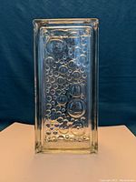 Top down view showing bubble texture on the surface of the glass block vase.