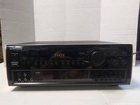 Front view of the Pioneer Elite VSX-97 receiver powered off showing its black exterior, central volume knob, and multiple input ports.