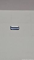 Front view of 1.36 carat emerald cut natural aquamarine gemstone showing clear lagoon blue color and polished facets.