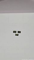 Three emerald cut green sapphires displayed on white background, showing size and color.