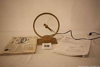 Photo of the Jefferson Mystery Golden Hour clock with power cord and instruction/repair papers laid out on a surface.