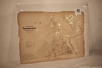 Photo of original Phoenixville map plate showing entire map mounted in protective sleeve with worn edges.