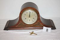 Full frontal image of the Seth Thomas mantle clock with key and lot number marker.
